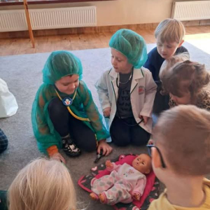 Dzieci siedzą na dywanie