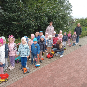 dzieci z grupy Biedronki podczas przemarszu z autkami na sznurku