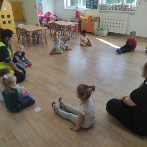 Dzieci siedzące w kole podczas wizyty pani policjantki