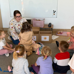 Dzieci podczas zajęć segregują ubrania letnie i jesienne