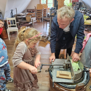 Dziewczynka kręci korbą szatkownicy