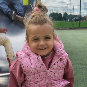 Dziewczynka zjeżdża na zjeżdżalni.