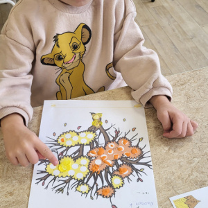 Chłopiec wykonuje pracę plastyczną.