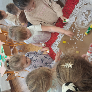 Dziecko wykleja angielska budkę telefoniczną kolorową bibułą