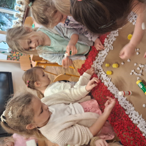 Dziecko wykleja angielska budkę telefoniczną kolorową bibułą