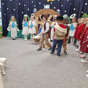 Pasterze kładą dary przy żłóbku z Dzieciątkiem Jezus