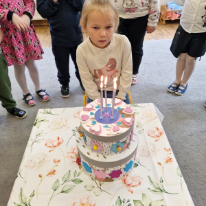 Dziewczynka przygotowuje się do zdmuchnięcia świeczek