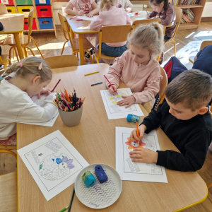 Dzieci w czasie zajęć plastycznych przygotowują upominek dla mamy z okazji Dnia Kobiet